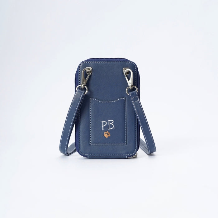A navy blue faux-leather crossbody phone bag with silver hardware, featuring a front pocket with white embroidered initials 'PB' and a small orange paw print, shown on a white background.