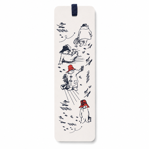 A tall, narrow cream-colored paper bookmark featuring a whimsical black ink sketch of paddington bear in winter clothing, with one wearing a red hat. The bookmark is suspended from a dark navy blue ribbon at the top, set against a clean white background.