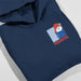 A navy blue hoodie folded on a light gray background, featuring a graphic print of Paddington Bear wearing a red hat and blue coat with the word 'PADDINGTON' in red text.