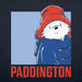 A graphic print featuring Paddington Bear wearing his signature red hat and blue duffel coat, with the word 'PADDINGTON' in large red letters below, shown on a dark navy blue textured background.