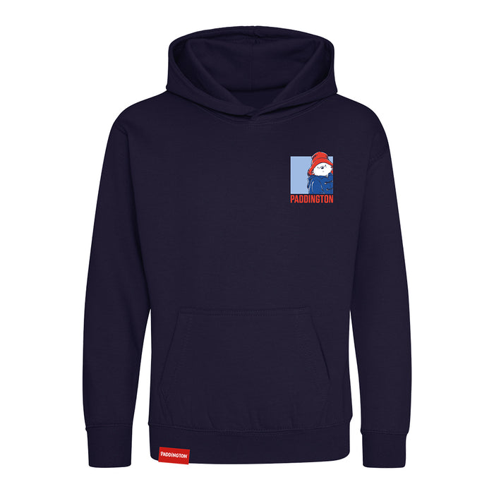 A navy blue pullover hoodie with a small graphic on the left chest featuring a cartoon bear character and the word 'PADDINGTON' in red, plus a small red tag near the bottom hem.