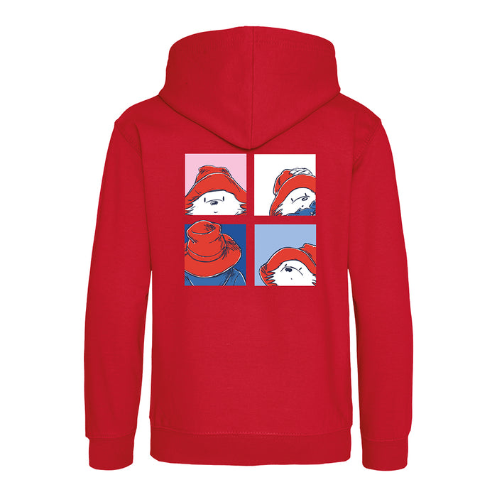 A red pullover hoodie shown from the back, featuring a graphic print of a cartoon Paddington character wearing a red hat in a four-panel comic style.