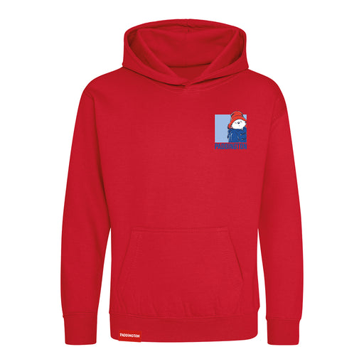 A red pullover hoodie with a small graphic on the left chest depicting a cartoon Paddington bear wearing a red hat and blue outfit, with the text 'PADDINGTON' below. The hoodie has a front kangaroo pocket and ribbed cuffs and hem, shown on a plain white background.