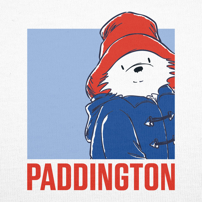 A square graphic print featuring the Paddington Bear character wearing a red hat and blue coat against a light blue background, with the word 'PADDINGTON' in large red letters below on a white textured field.