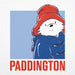 A square graphic print featuring the Paddington Bear character wearing a red hat and blue coat against a light blue background, with the word 'PADDINGTON' in large red letters below on a white textured field.