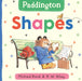 Book cover of 'Paddington Shapes' featuring Paddington Bear on a bench with colorful shapes around.