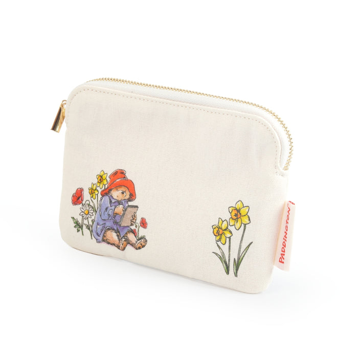 Small pouch with a design of paddington bear writing a letter and flowers on a white background