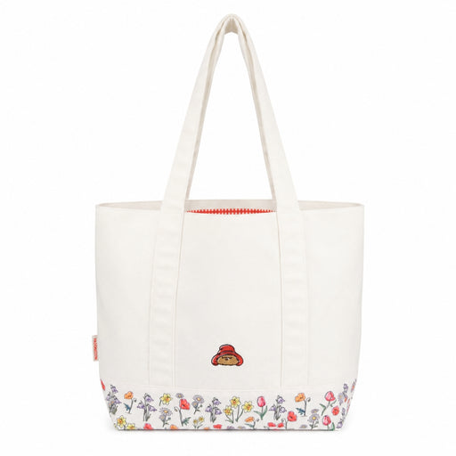 White shoulder tote bag with floral design and paddingtons face on a white background