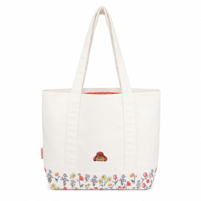 White shoulder tote bag with floral design and paddingtons face on a white background