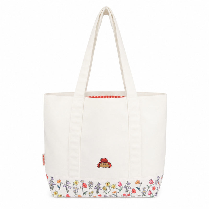 White shoulder tote bag with floral design and paddingtons face on a white background