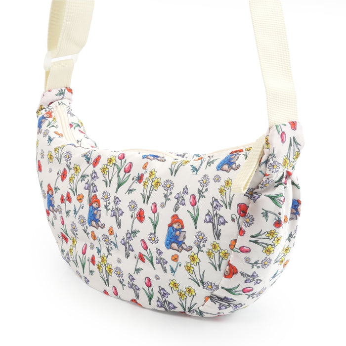 Floral patterned bag with cartoon Paddington bear characters on a white background