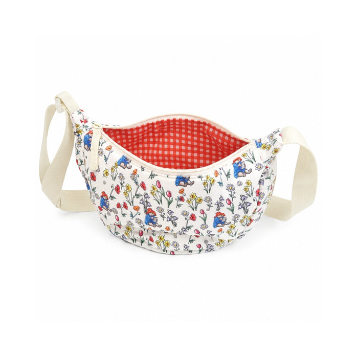 Fabric basket with floral pattern and red interior on a white background