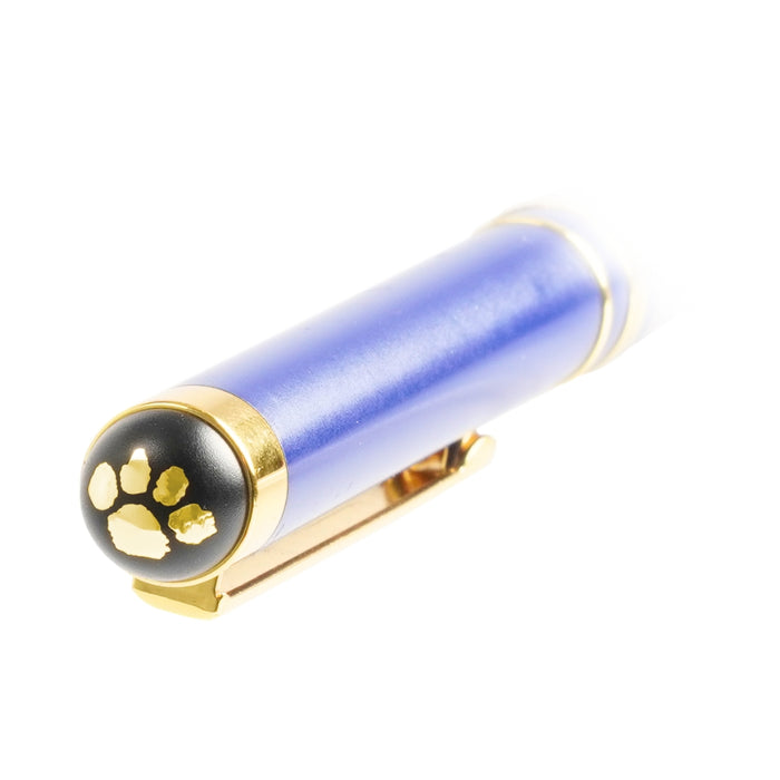 Blue cylindrical object with gold accents and a paw print design on a white background
