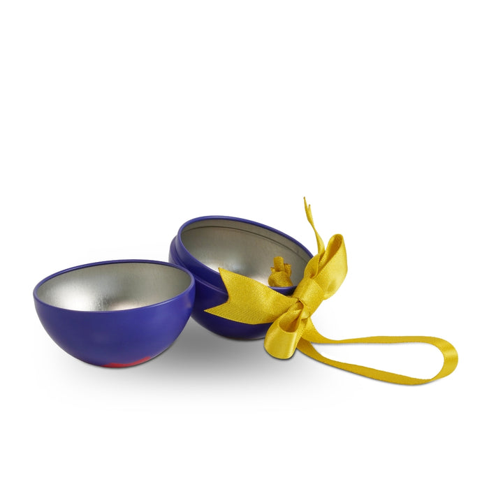 A small round metal fillable christmas bauble shown open, with a deep blue exterior, silver-toned interior, and a bright yellow ribbon tied in a bow, photographed on a plain white background.