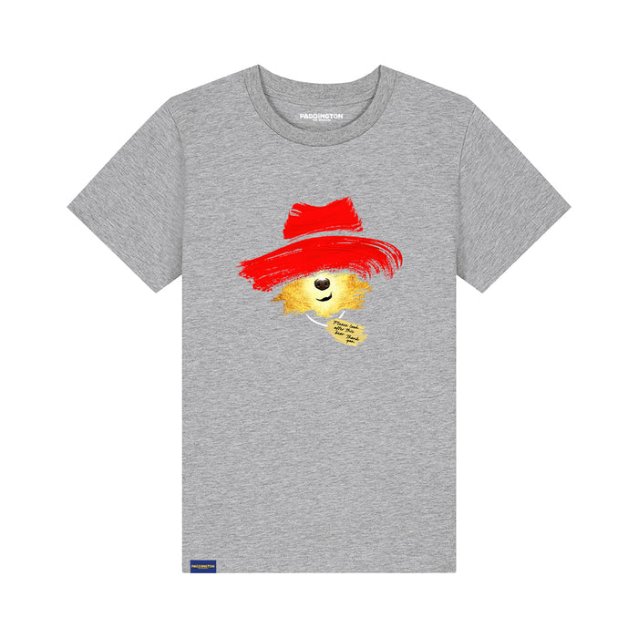 A heather gray short-sleeve t-shirt featuring a graphic of a Paddington bear wearing a red hat, with the text 'PADDINGTON THE MUSICAL' printed on the chest and a small blue tag near the bottom hem.