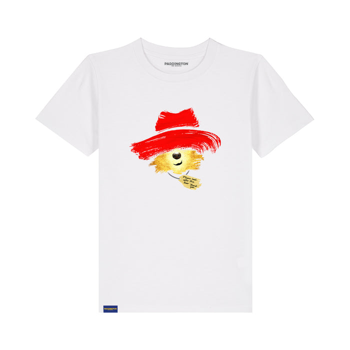 A white short-sleeve crewneck t-shirt featuring a graphic of a paddington bear wearing a red paint-brush hat, with the brand name 'PADDINGTON THE MUSICAL' printed inside the collar.