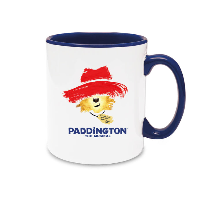 Mug with Paddington Bear design and 'Paddington The Musical' text on a white background