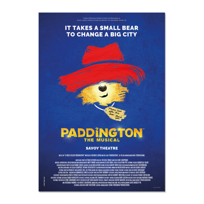 Promotional poster for 'Paddington: The Musical' with a bear wearing a red hat on a blue background.