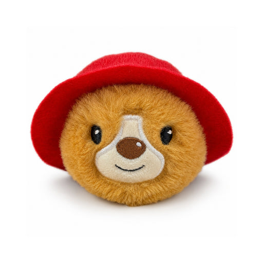 A round Paddington bear plush toy beanie bouncer ball with golden-brown fur wearing a bright red hat, photographed on a clean white background.