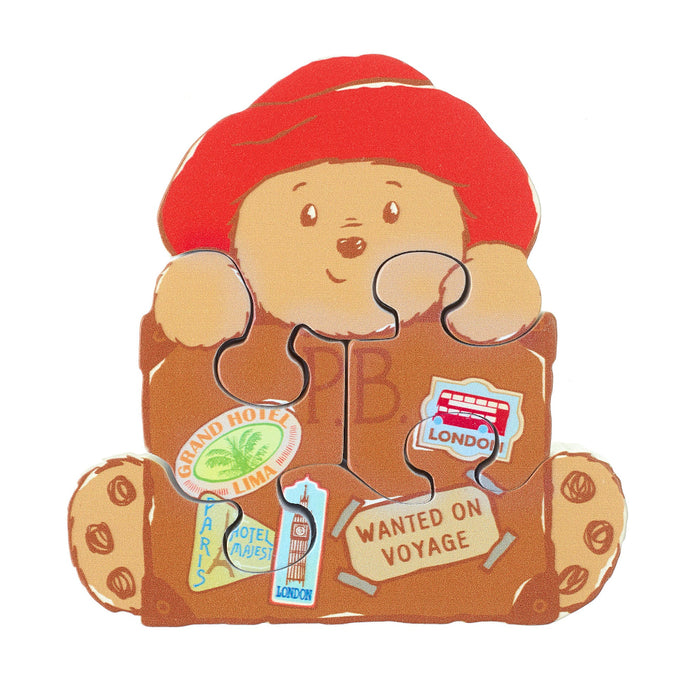 Illustrated teddy bear pzzle with travel-themed accessories on a white background