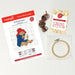 Paddington Cross stitch kit with pattern, thread, and hoop on a light background