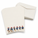 A stack of cream-colored stationery cards featuring a row of Paddington Bear illustrations along the bottom edge, shown with matching cream envelopes on a white background.