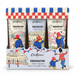 A boxed set of three Cath Kidston x Paddington hand creams in a decorative display tray. The packaging features a red, white, and blue checkered top, and the three cream tubes are illustrated with Paddington in red and blue outfits against city and garden backgrounds.
