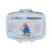 A rectangular compact mirror with rounded corners, featuring a silver metal frame and a light blue illustrated lid. The lid shows a cartoon scene of Paddington Bear walking with a suitcase, with the text 'Cath Kidston x PADDINGTON' at the top.