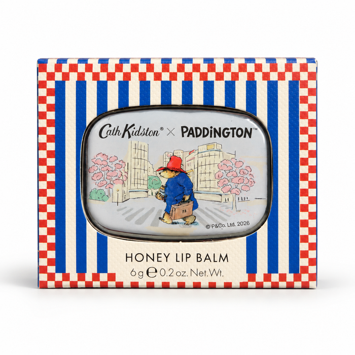 Cith Kidston x Paddington Honey Lip Balm in its original packaging, featuring a red, white, and blue checkered border with a central illustration of Paddington Bear.