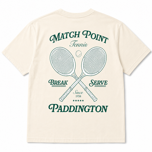 An off-white short-sleeve t-shirt showing the back, which features a dark green graphic print with crossed tennis rackets, a tennis ball, and the text 'MATCH POINT Tennis BREAK SERVE Since 1958 PADDINGTON'.