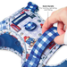 A close-up of a Paddington-themed harness being worn by a dog, with a hand adjusting the blue and white gingham strap. The harness features a white mesh base printed with Paddington bear illustrations and blue gingham accents.