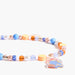 A beaded phone charm strap with pastel blue, orange, pink, and white beads, featuring a small illustrated paddington charm on a gold chain, set against a plain white background.