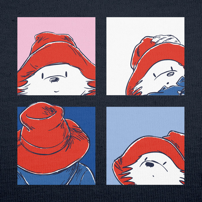 A square graphic print featuring four panels in a pop-art style, showing Paddington bear's face wearing a red hat, set against pink, white, blue, and light blue backgrounds, all arranged in a 2x2 grid on a dark navy textured background.