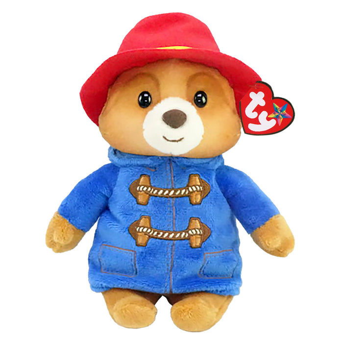 A plush toy resembling the character Paddington Bear, with a red hat and a blue coat with button details.
