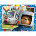 paddington bear in a space helmet with a vehicle and people in the background