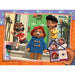 paddington characters in a scene with a door, holding a book with character illustrations.
