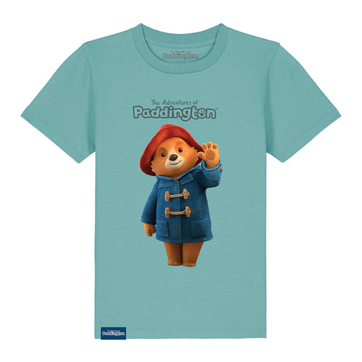A blue kids' T-shirt with a graphic of Paddington Bear in a red hat and blue coat on a teal background, with the text 'The Adventures of Paddington'.