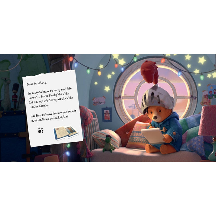 A children's bedroom scene with Paddington bear dressed as a knight sitting by a round window and writing a letter, next to a handwritten note addressed to 'Aunt Lucy'.