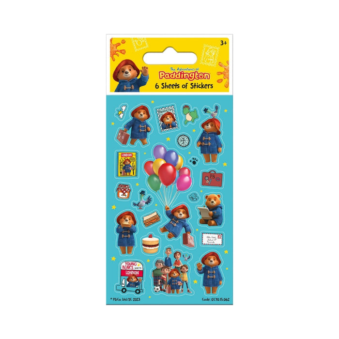 Paddington-themed sticker sheet package with multiple illustrated stickers on a turquoise backing card, including Paddington Bear, balloons, a suitcase, and small character scenes. The header reads 'Paddington 6 Sheets of Stickers' with a yellow background.