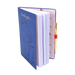 Blue notebook with a Paddington bear character design on the cover, open to reveal white pages and a gold pen.