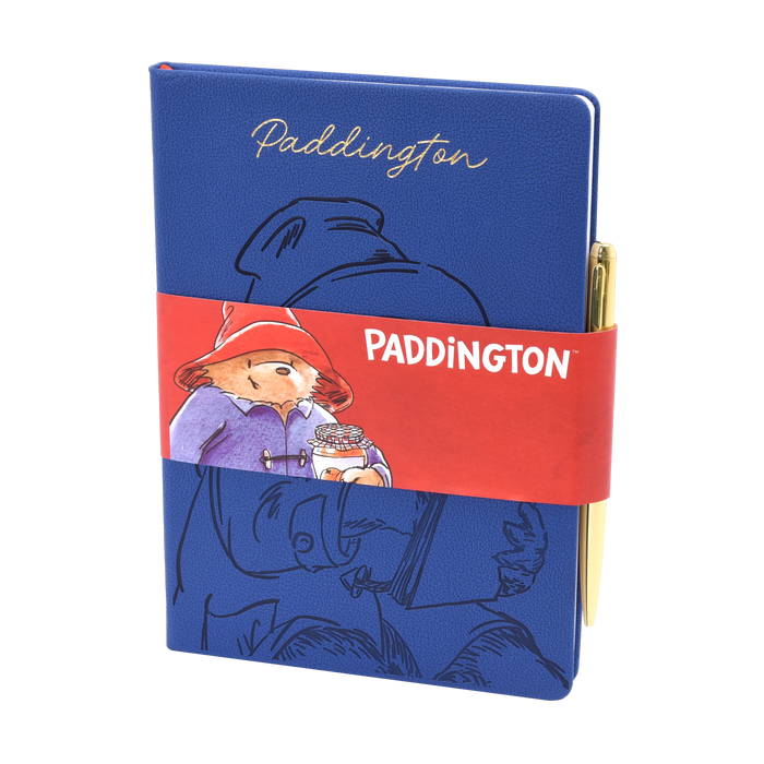 Blue notebook an gold pen with Paddington Bear design and red band featuring Paddington Bear holding a jar of marmalade.