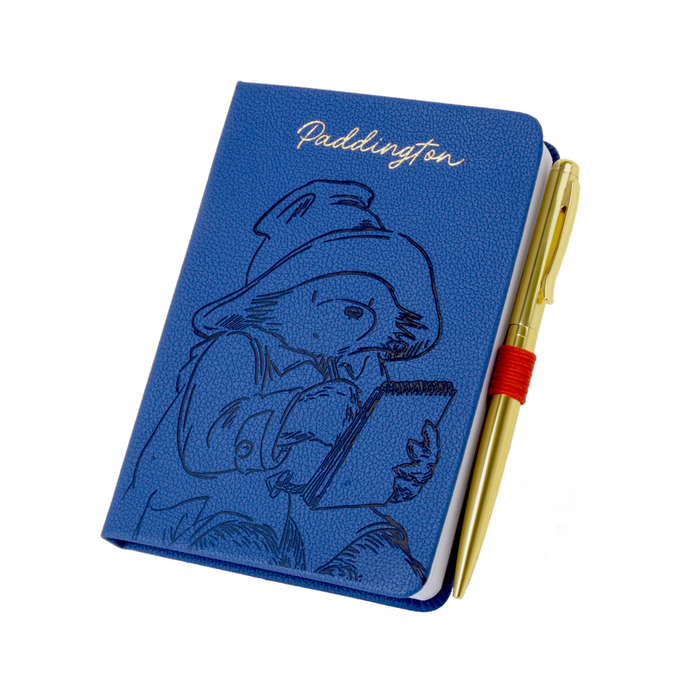 Blue notebook with Paddington Bear illustration and a gold pen on a white background