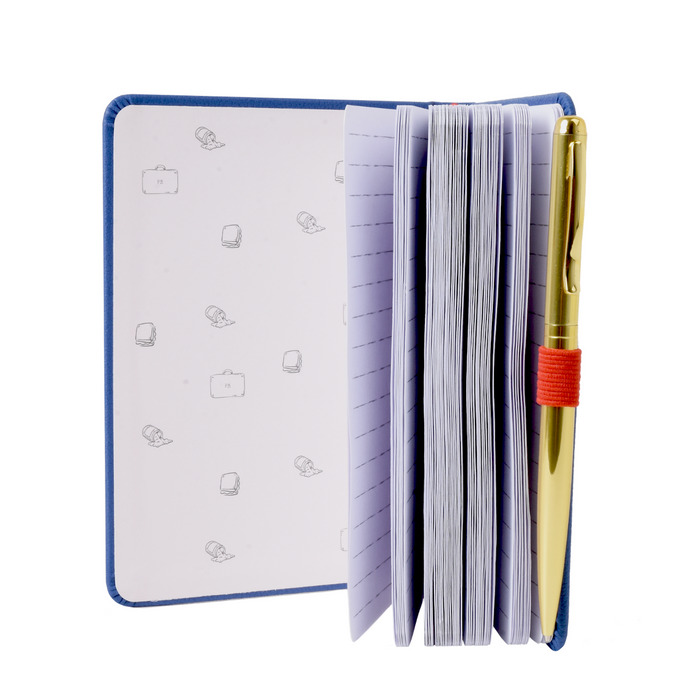 Open Paddington notebook with lined pages and a pen holder, featuring a pen on a white background.