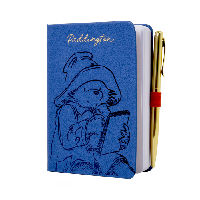 Blue notebook with Paddington Bear illustration and a pen on a white background