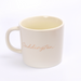 Cream mug with gold 'Paddington' text on a white background