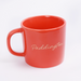 Red mug with gold 'Paddington' text on a white background