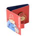 Red box with Paddington Bear illustrations and a brass enamel Paddington badge on a white background