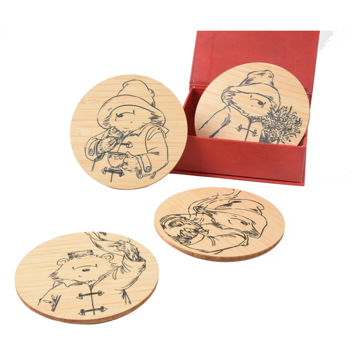Set of wooden coasters with Paddington bear illustrations in a red box on a white background
