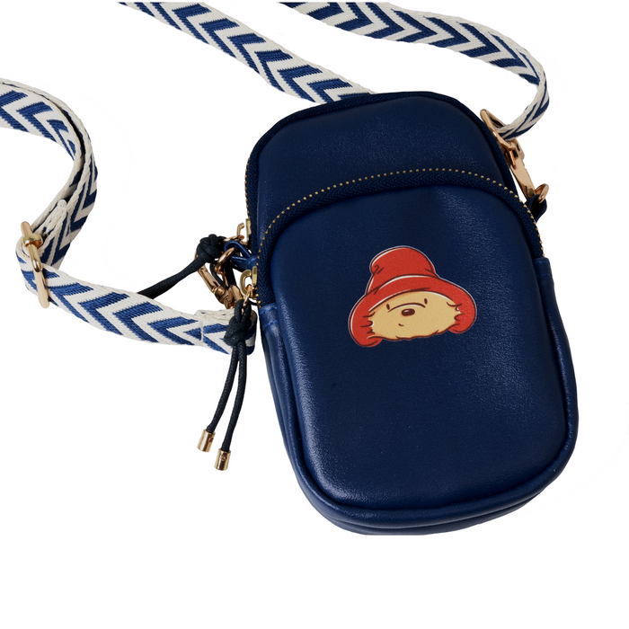 Navy blue crossbody bag with Paddington bear character on strap against a white background