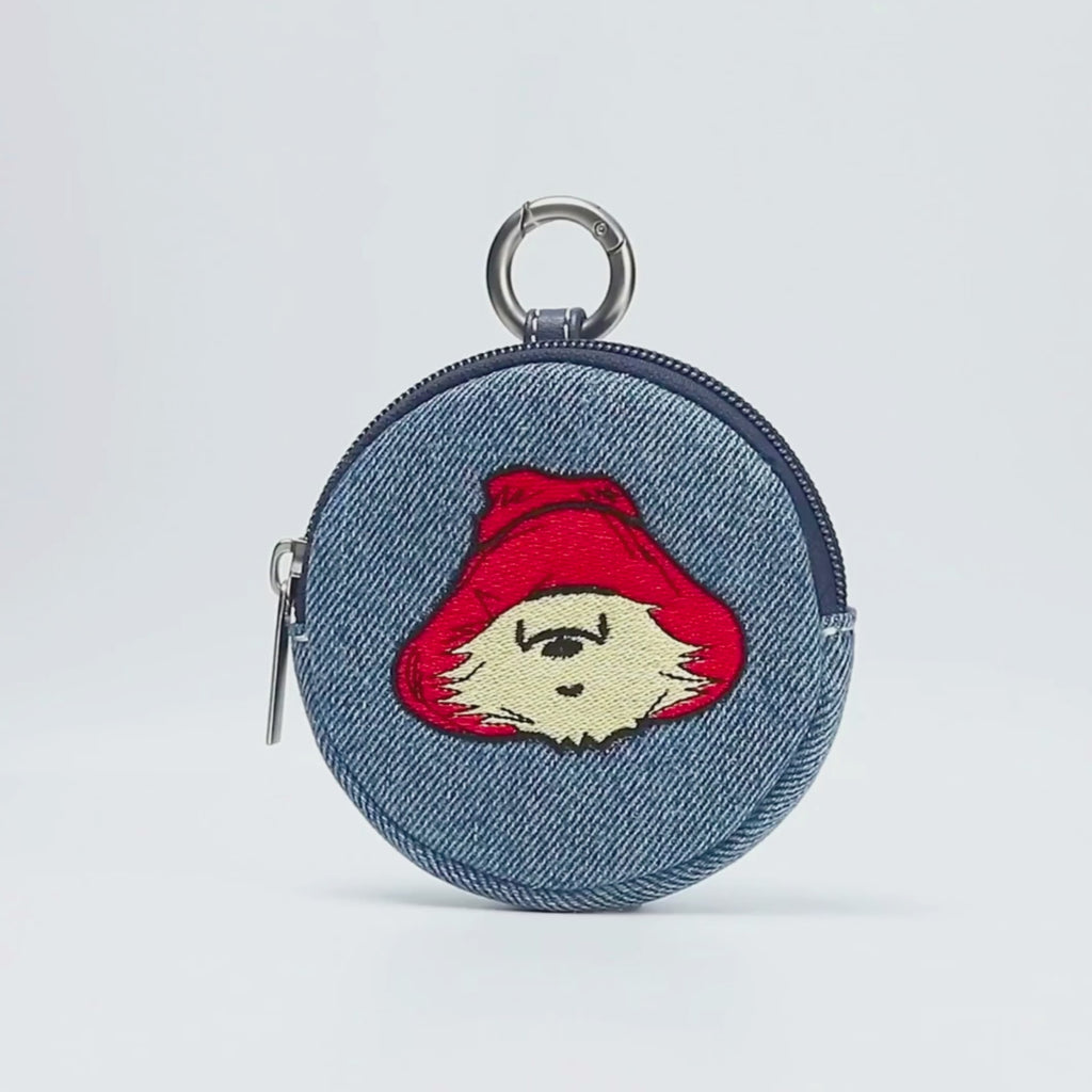 Paddington P.B. Collection denim bubble purse featuring a Paddington face design and zip fastening shown in close-up.